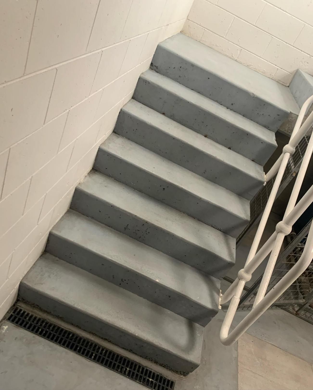 A Set of Concrete Stairs With a White Railing — Holster Painting Contractors In Port Macquarie, NSW 