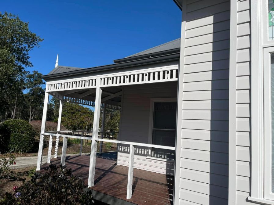A White House With a Porch and a Blue Sky in the Background — Holster Painting Contractors In Port Macquarie, NSW
