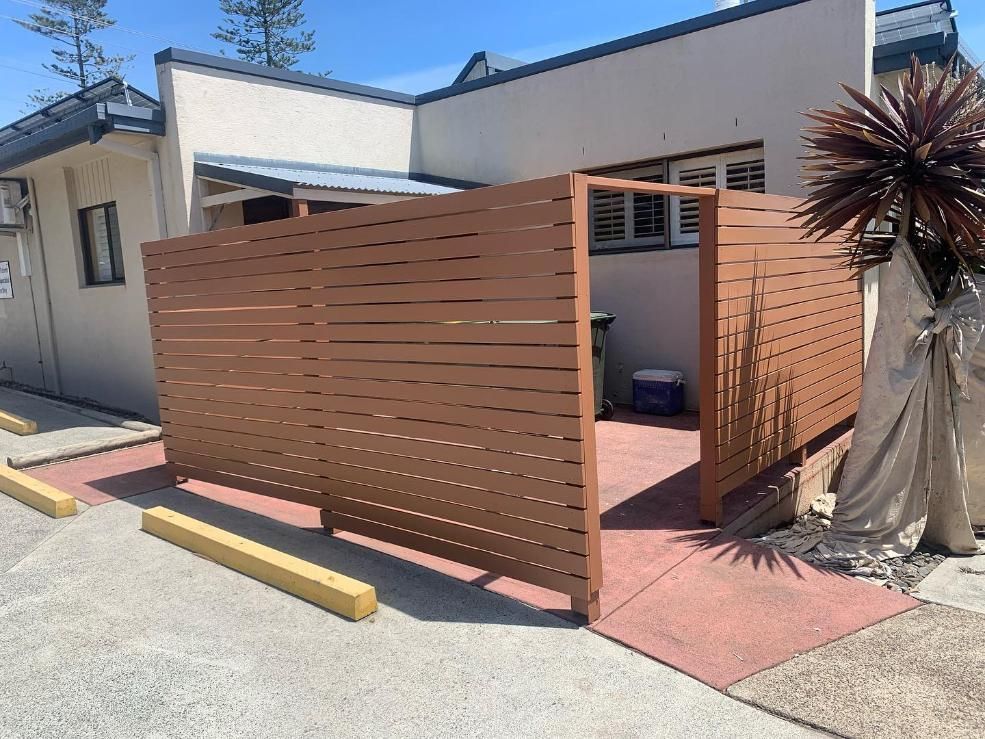 A Wooden Fence is Sitting in Front of a Building — Holster Painting Contractors In Port Macquarie, NSW 
