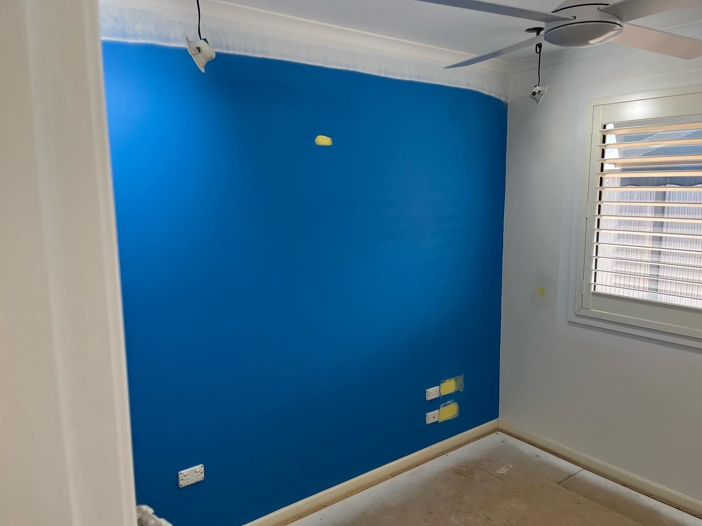 A Room With a Blue Wall and a Ceiling Fan — Holster Painting Contractors In Port Macquarie, NSW
