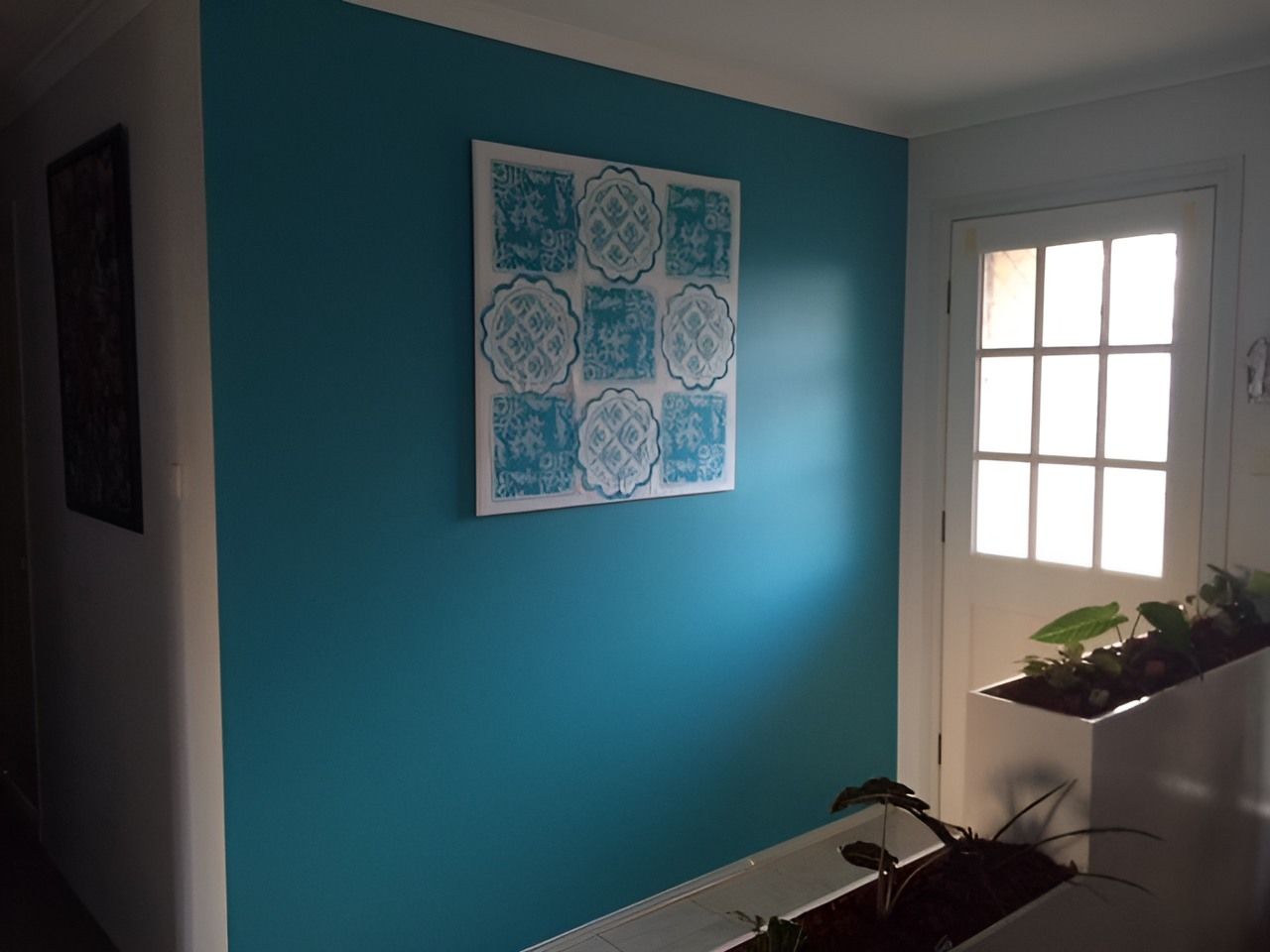 A Picture is Hanging on a Blue Wall in a Hallway — Holster Painting Contractors In Port Macquarie, NSW 