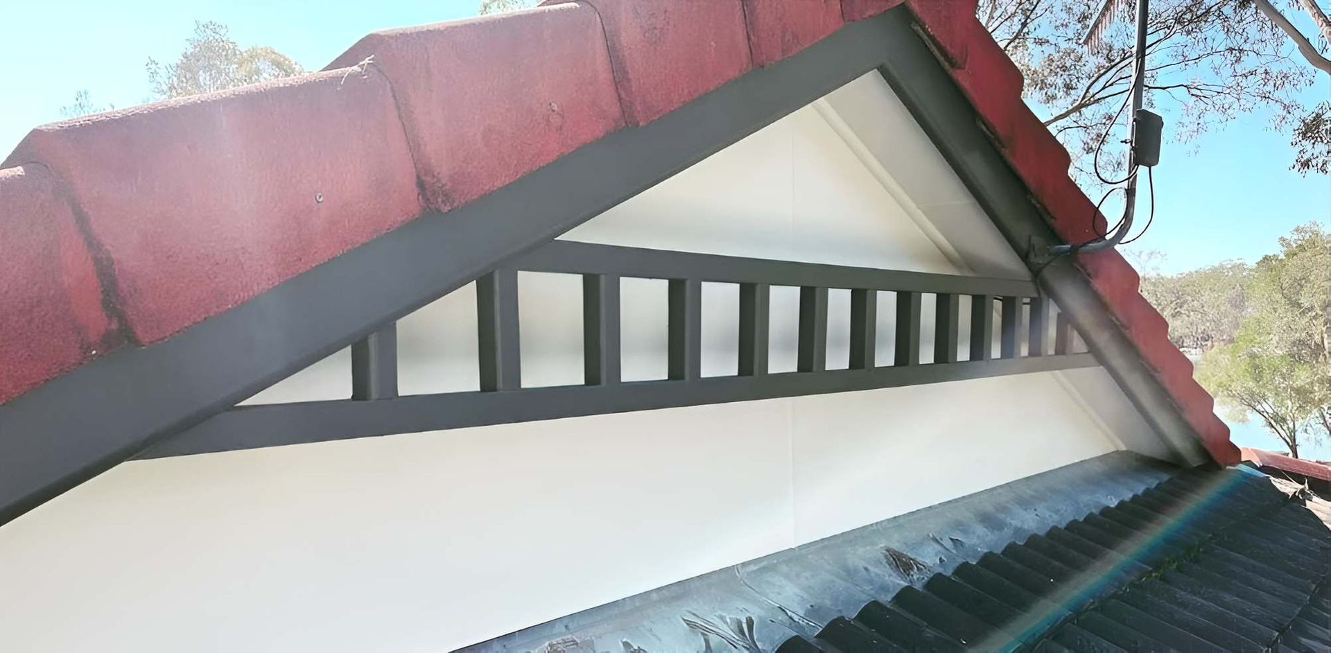 A Roof With a Red Tile Roof and a White Roof With a Black Trim — Holster Painting Contractors In Port Macquarie, NSW 