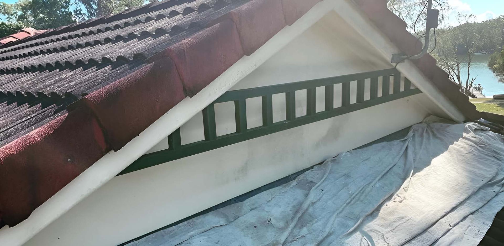 The Roof of a House is Being Painted White and Green — Holster Painting Contractors In Port Macquarie, NSW 