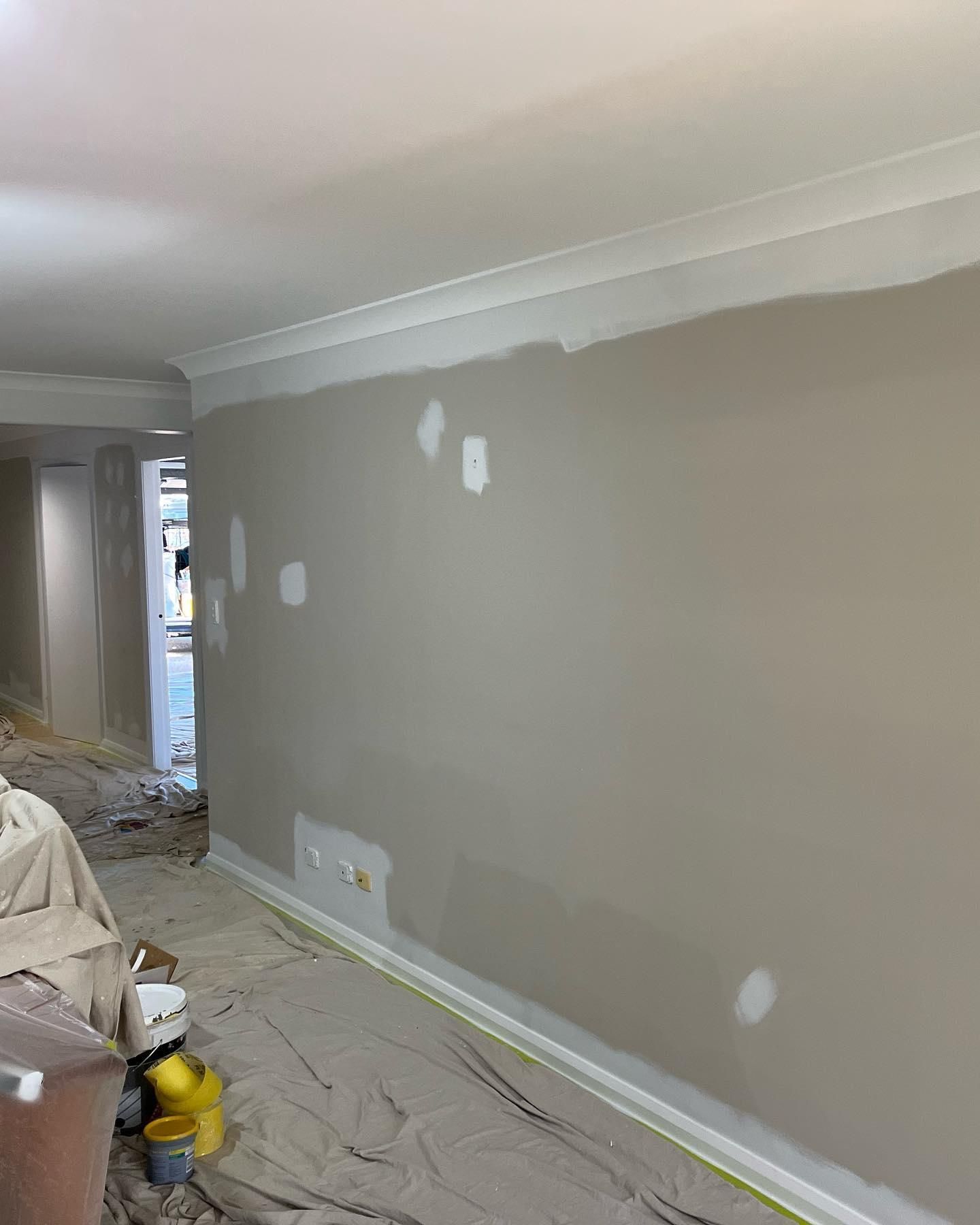 A Living Room is Being Painted in a Beige Color — Holster Painting Contractors In Lake Cathie, NSW