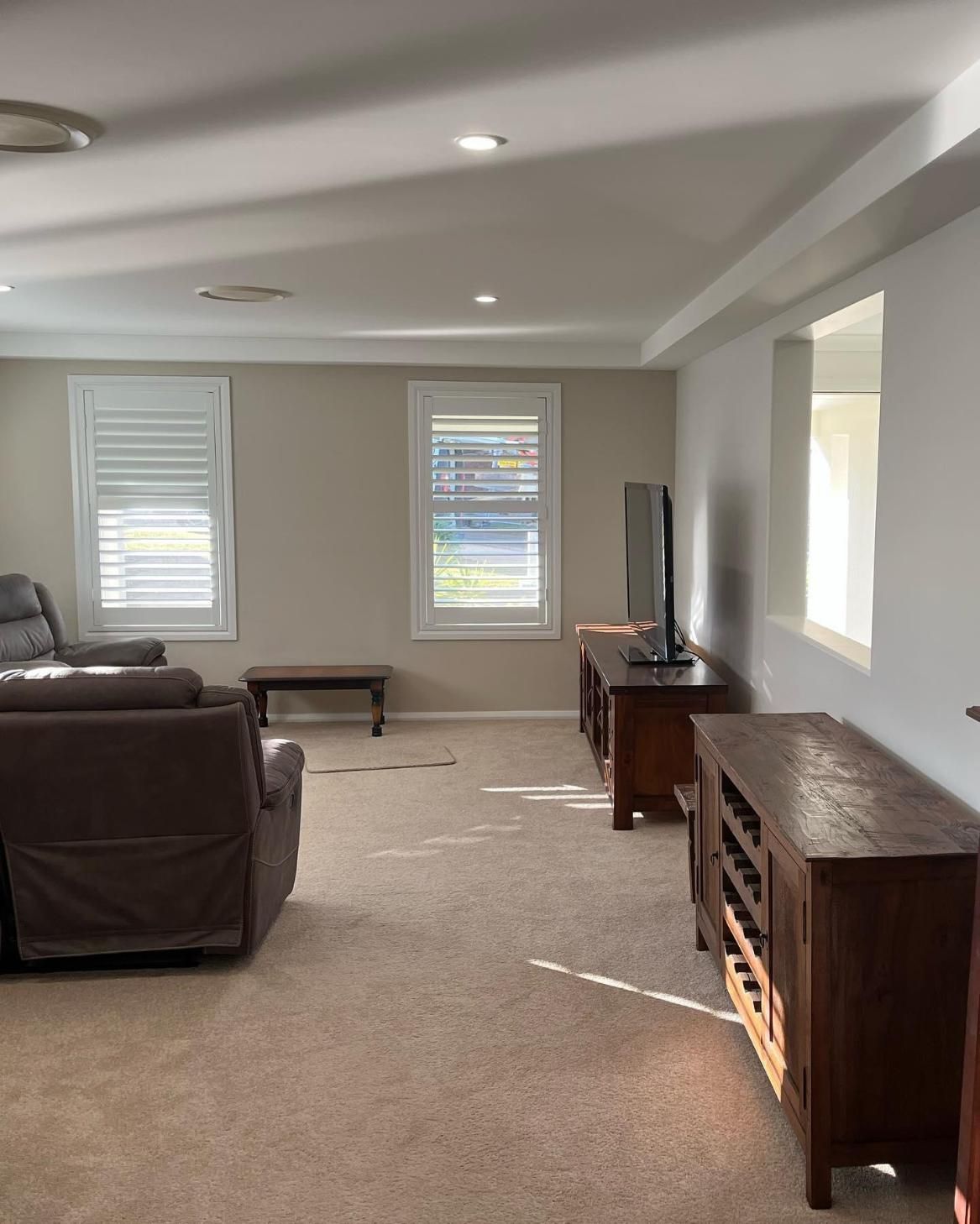 A Living Room With a Couch , Chair , and Television — Holster Painting Contractors In Wauchope, NSW