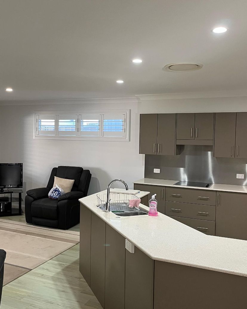 A Living Room With a Kitchen and a Chair — Holster Painting Contractors In Kendall, NSW 