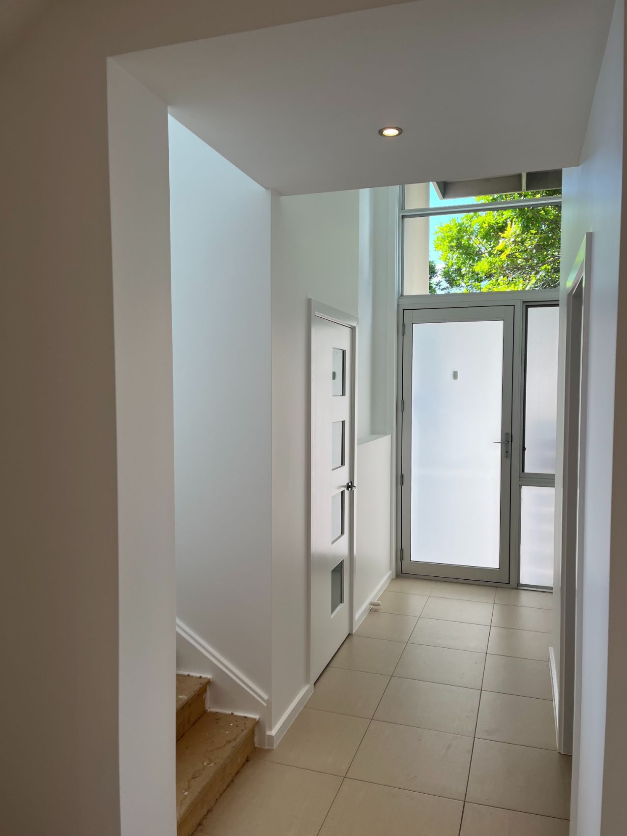A Hallway With Stairs and a Door That Has the Letter P on It — Holster Painting Contractors In Port Macquarie, NSW