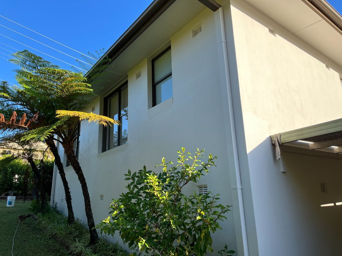 A White House With a Lot of Windows and Trees in Front of It — Holster Painting Contractors In Port Macquarie, NSW