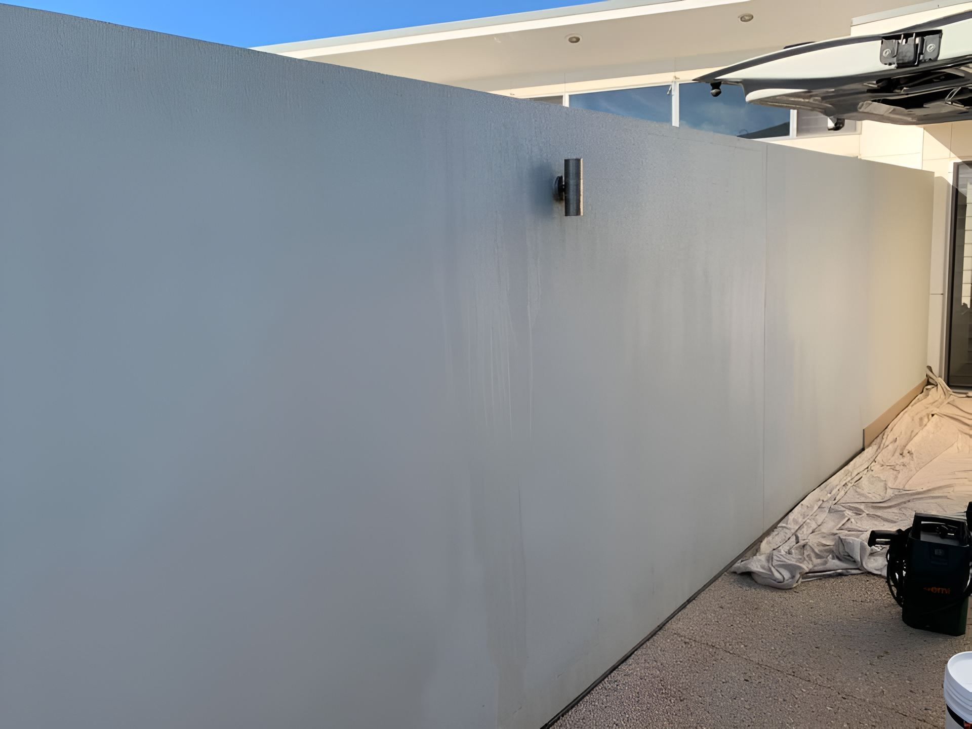 A White Wall is Being Painted in Front of a House — Holster Painting Contractors In Port Macquarie, NSW 