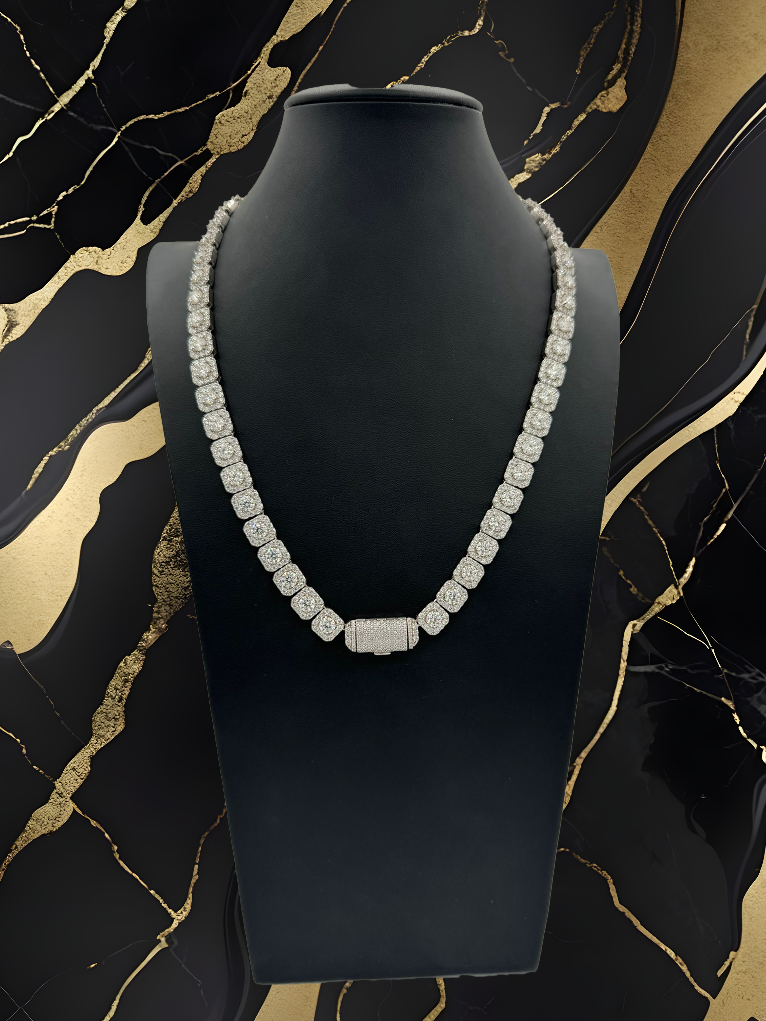 A necklace is on a mannequin against a black and gold background.