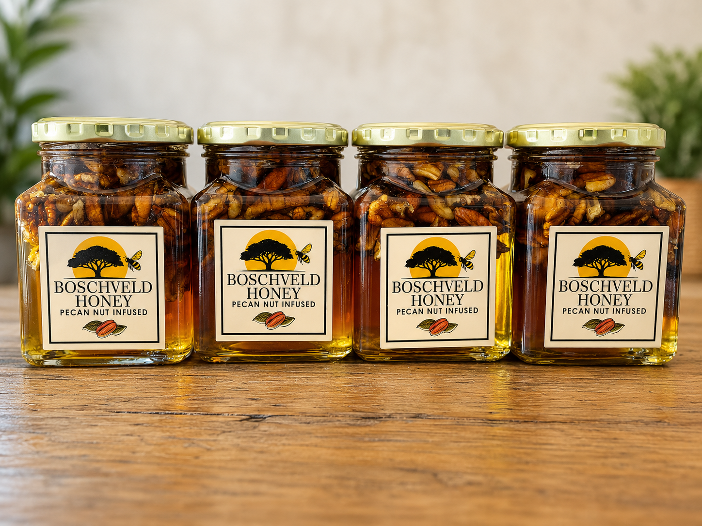 Four jars of chili crisp on a wooden table with gold lids and cream labels