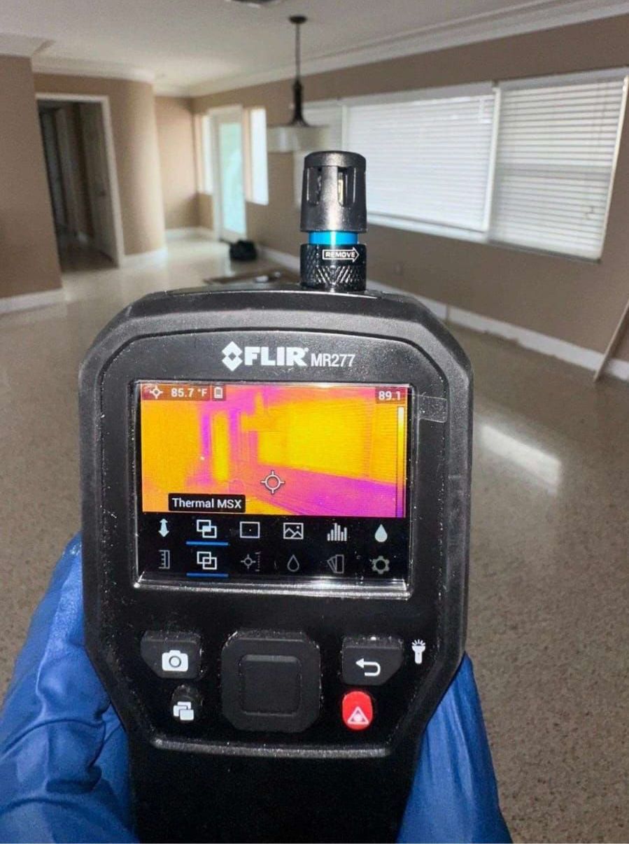 FLIR thermal imaging tool used by Spora Mold Remediation for detecting hidden moisture and mold inside walls.