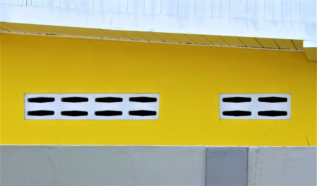 Yellow two storey wall — Pricing Guide in Brisbane, QLD