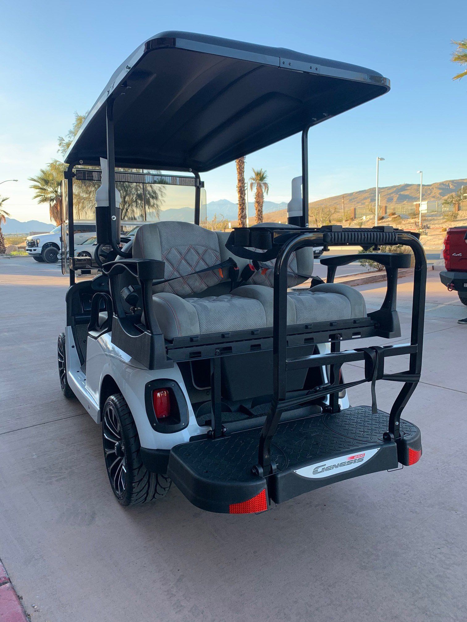 A golf cart is parked in a parking lot.