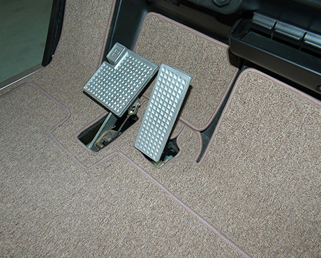A close up of a golf cart 's brake pedals