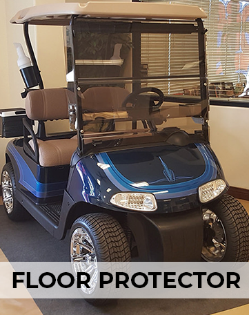 A blue golf cart is sitting on a black mat in a room.