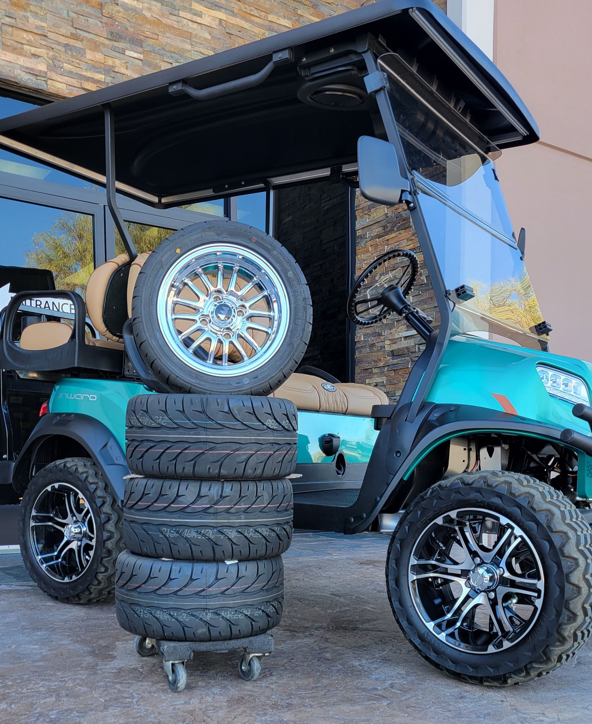 A golf cart with a stack of tires on top of it.