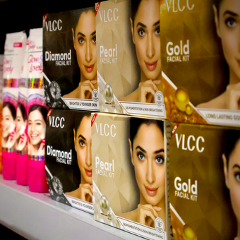 Boxes of vlcc facial kits are lined up on a shelf