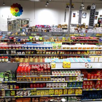 A grocery store aisle with a flower on the wall