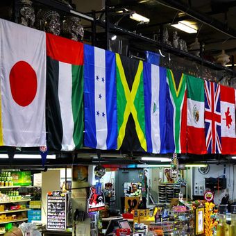 A row of flags with one that says ' mexico ' on it