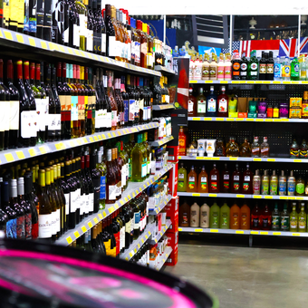 A store aisle filled with lots of bottles of alcohol