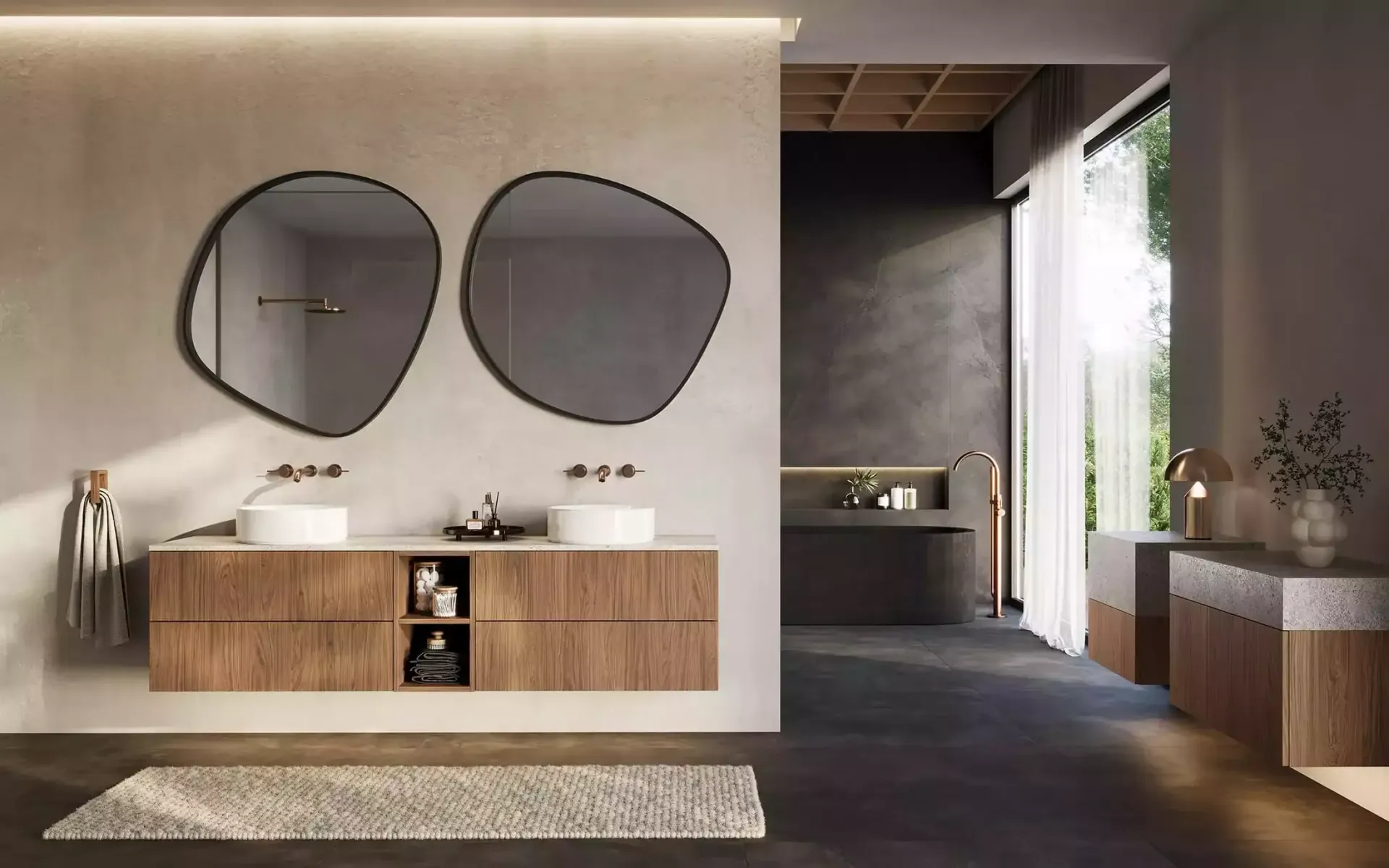 Moderne, minimalistische lobby met twee ronde spiegels, een houten receptiebalie en een gang die naar een wastafelgedeelte leidt.