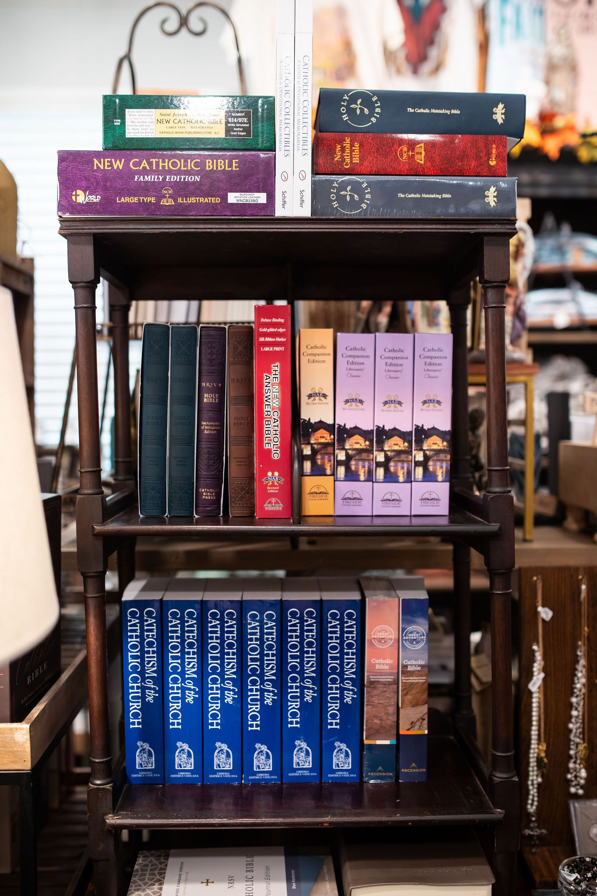 Wooden shelf holding various books with colorful spines in a dimly lit setting.