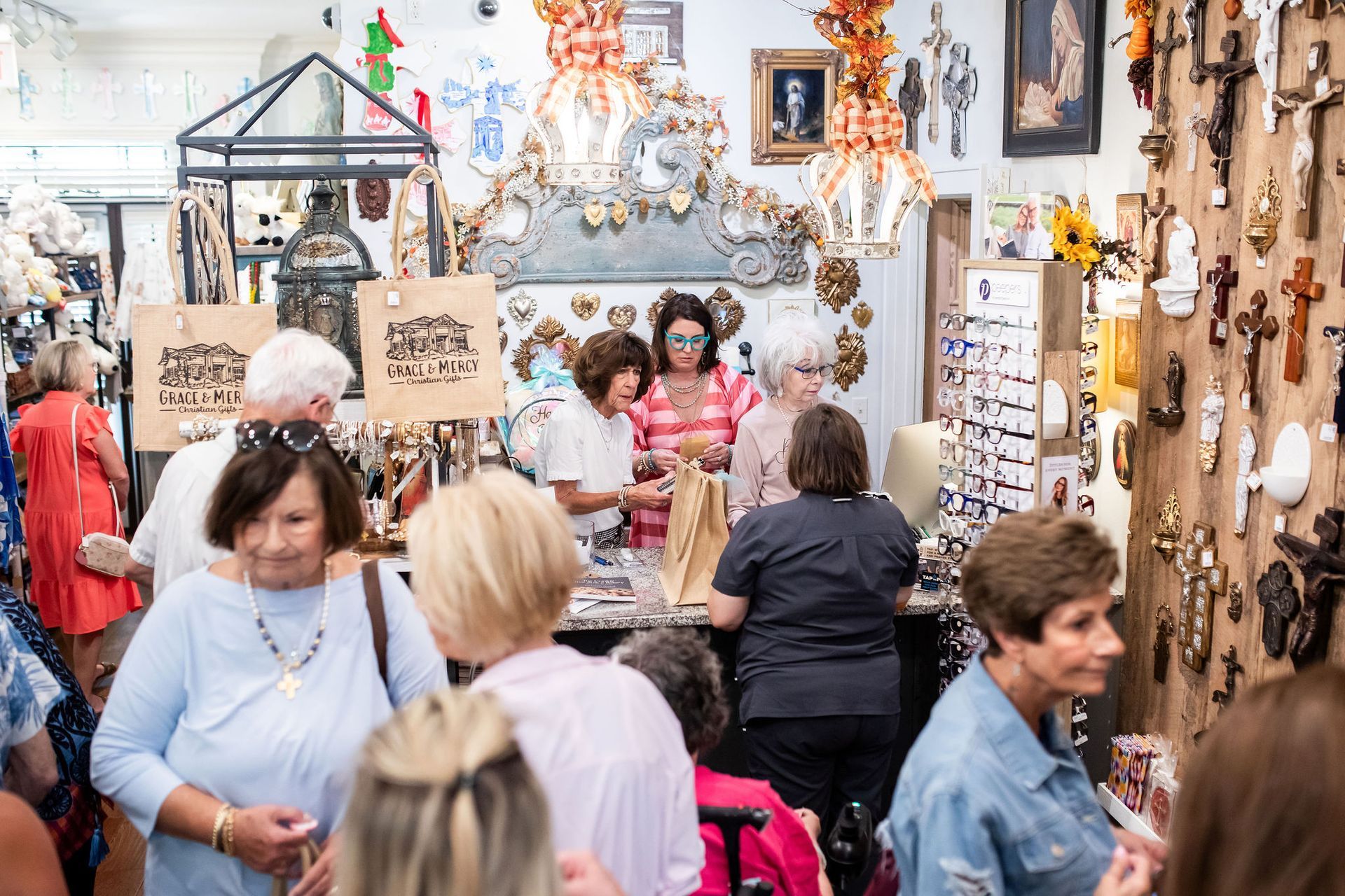 Shoppers browse merchandise in a store filled with items, including crosses.
