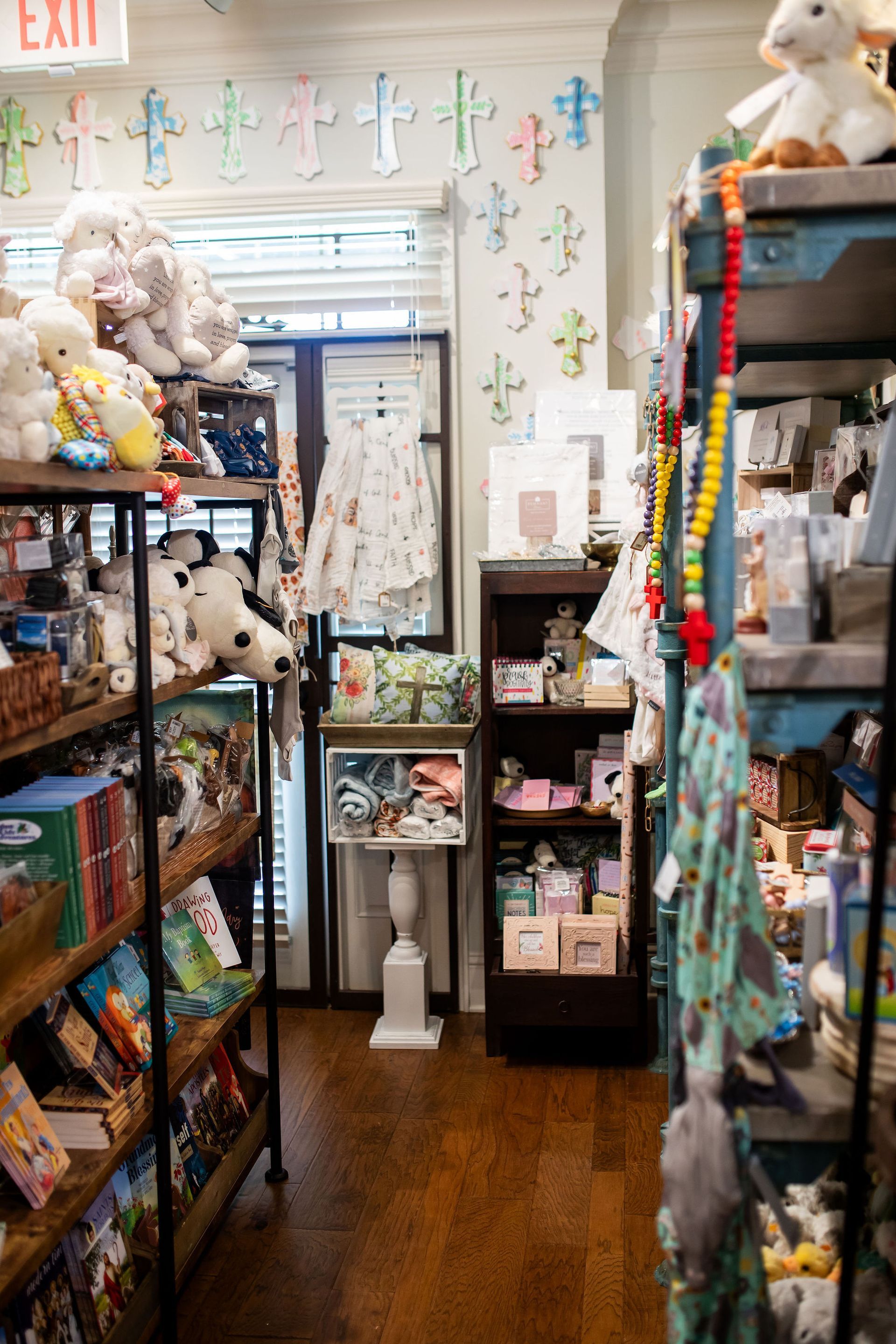 Interior of a gift shop with wooden shelves filled with toys, books, and other merchandise.