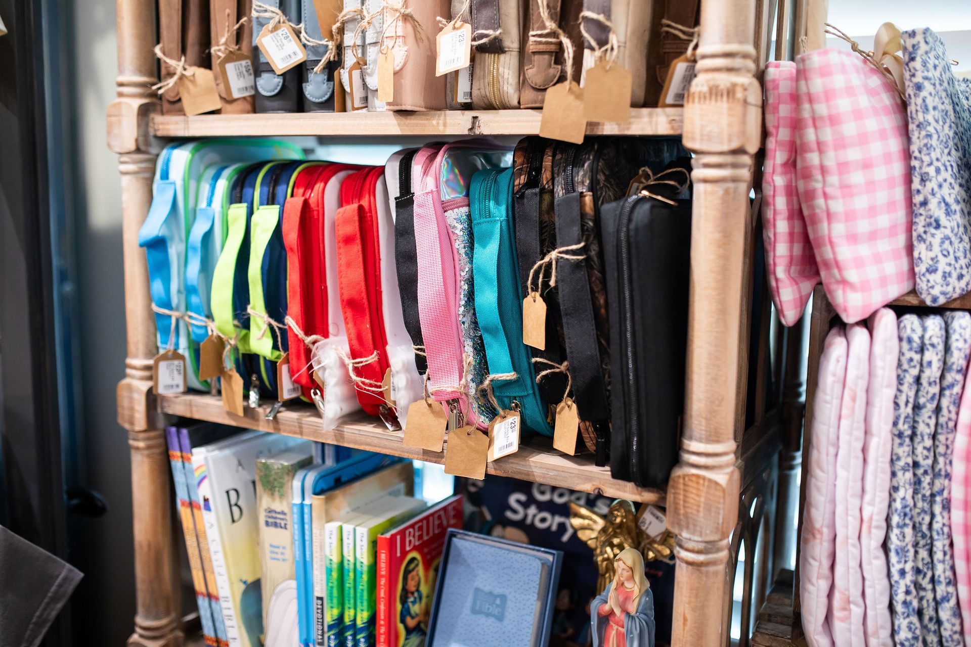 Shelf display with colorful bags, books, and accessories for sale.