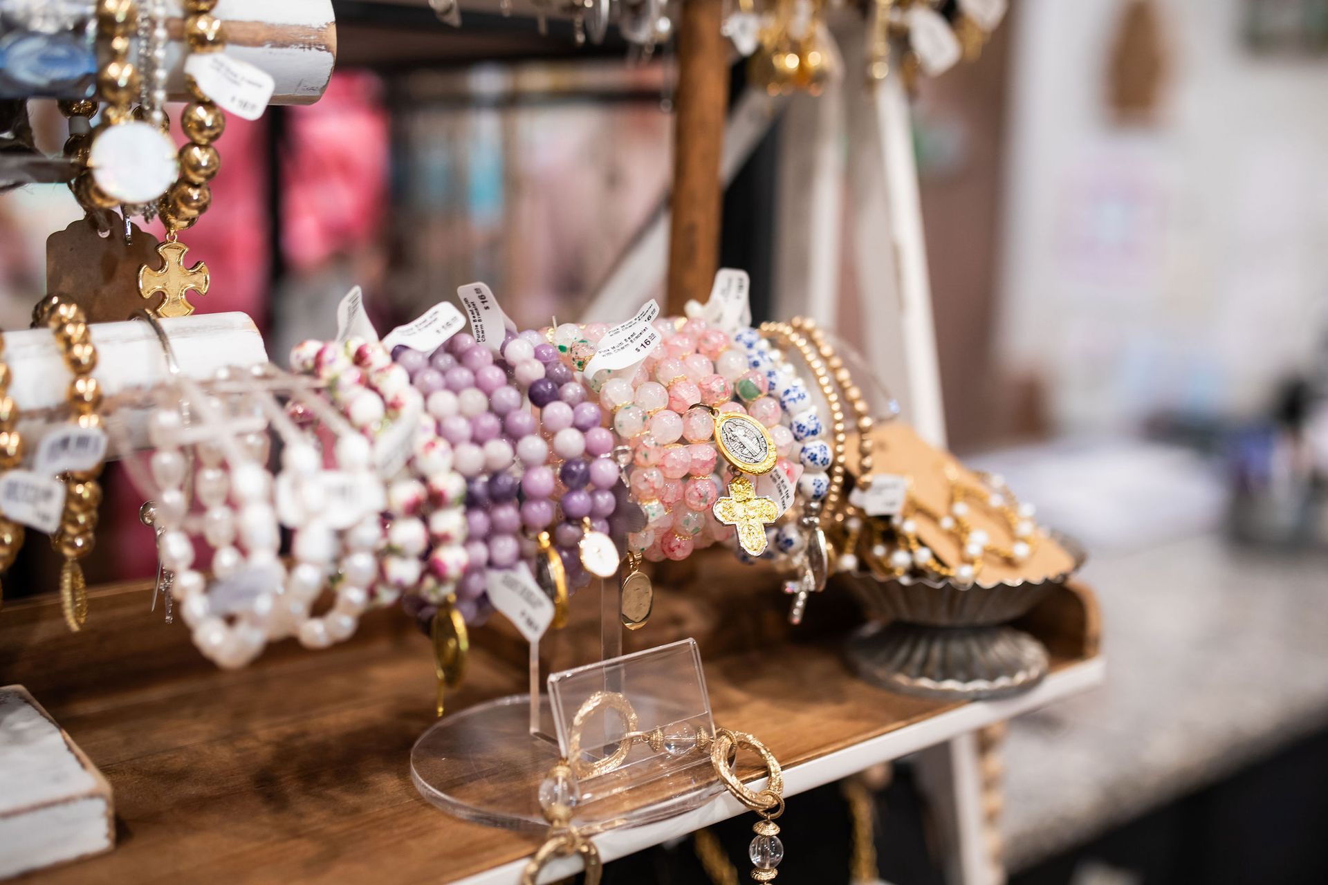 Jewelry display with beaded bracelets of various colors.