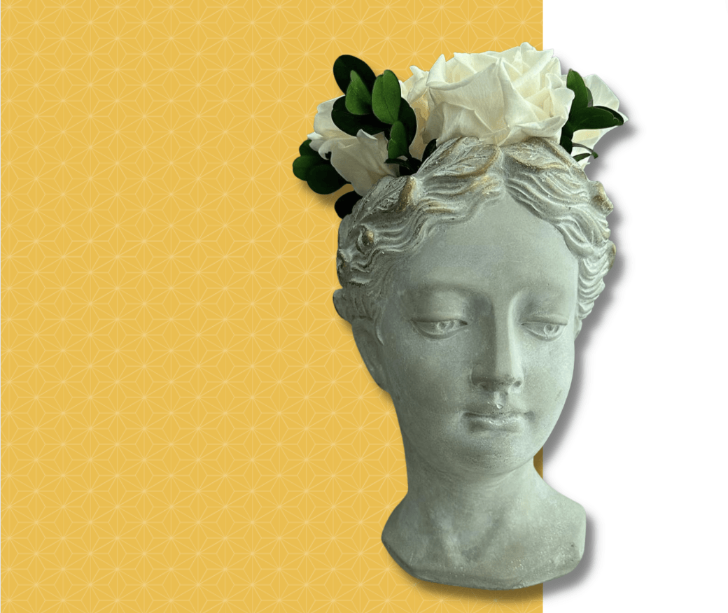 Stone head flower vase with white roses and greenery,