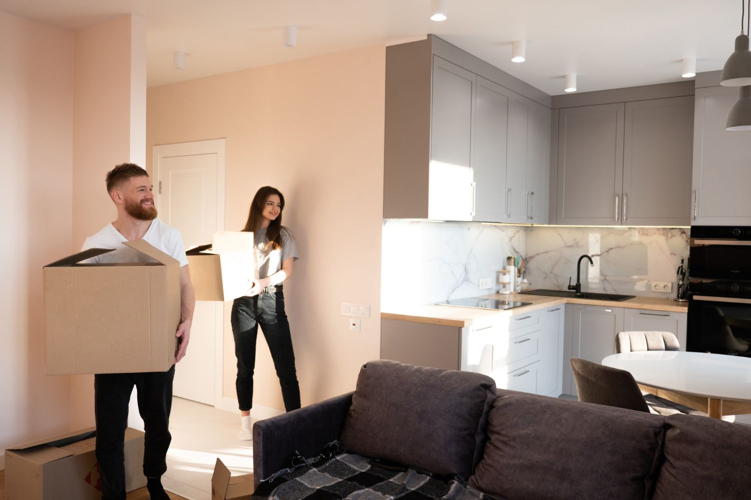 A man and a woman are moving into a new apartment.