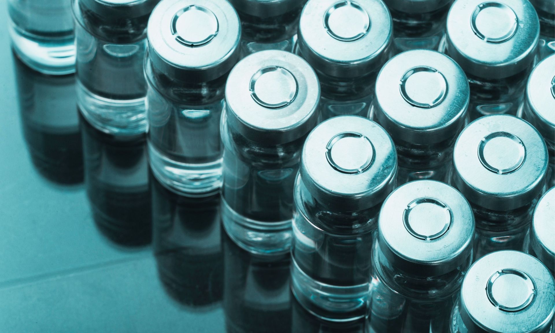 A bunch of bottles of medicine are stacked on top of each other on a table.