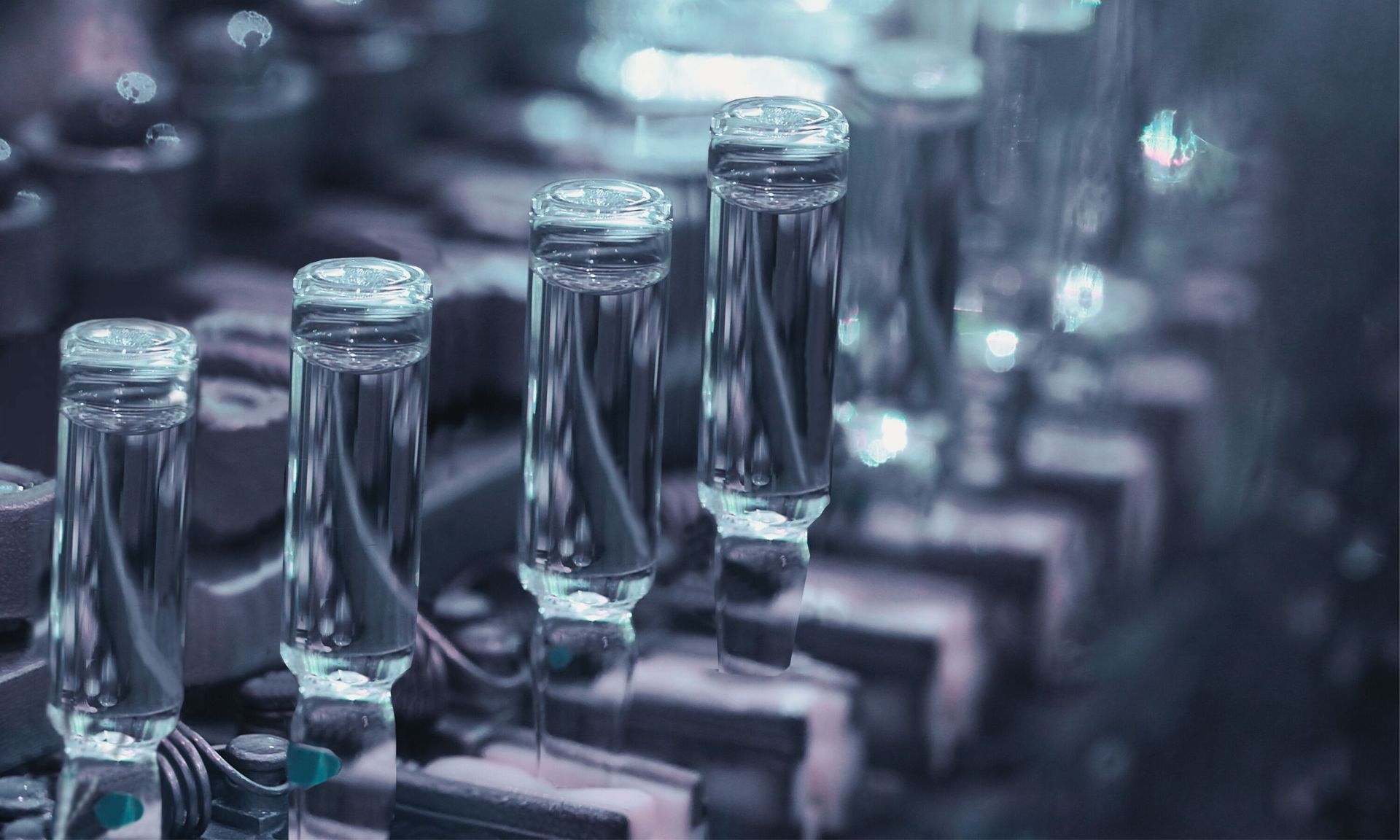 Addressing sustainability challenges in the pharmaceutical supply chain is crucial A conveyor belt filled with bottles of liquid in a laboratory.