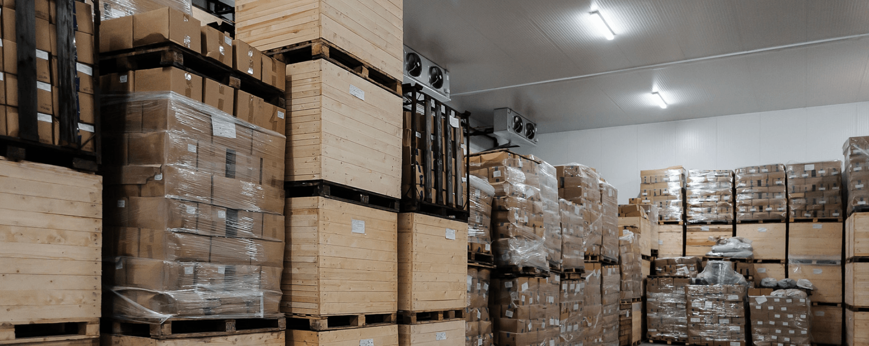 A large warehouse filled with lots of boxes and pallets.