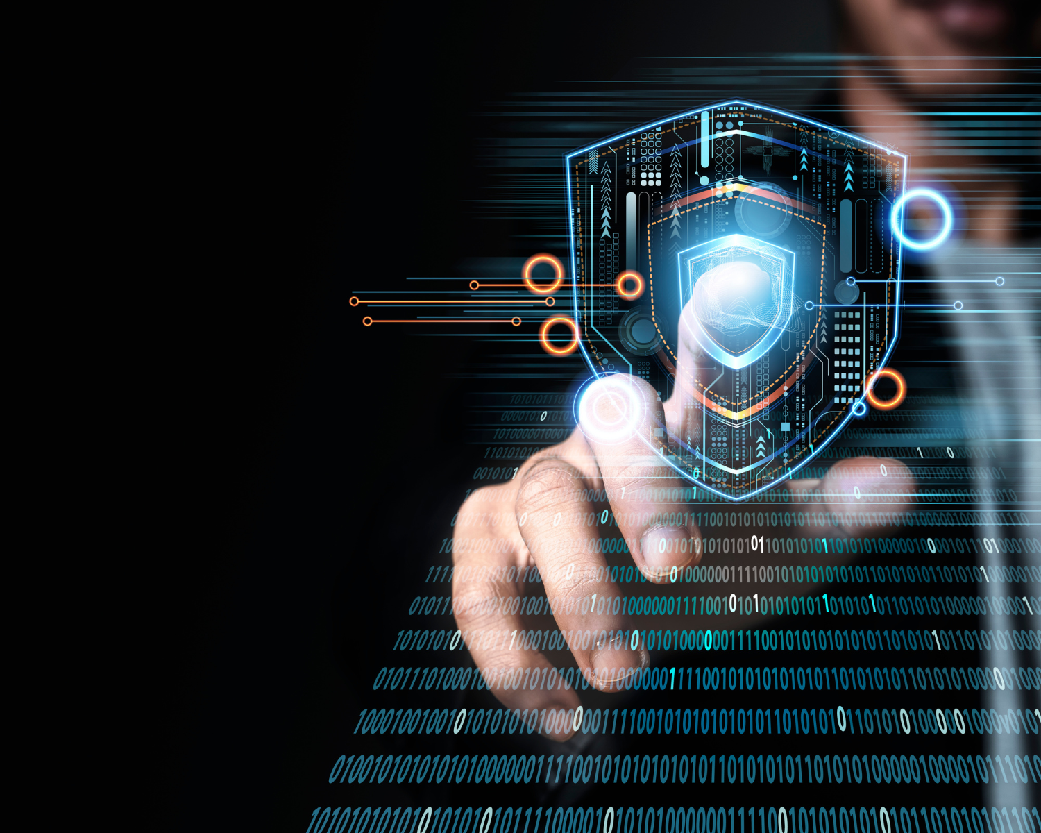 A man is touching a futuristic shield on a computer screen.