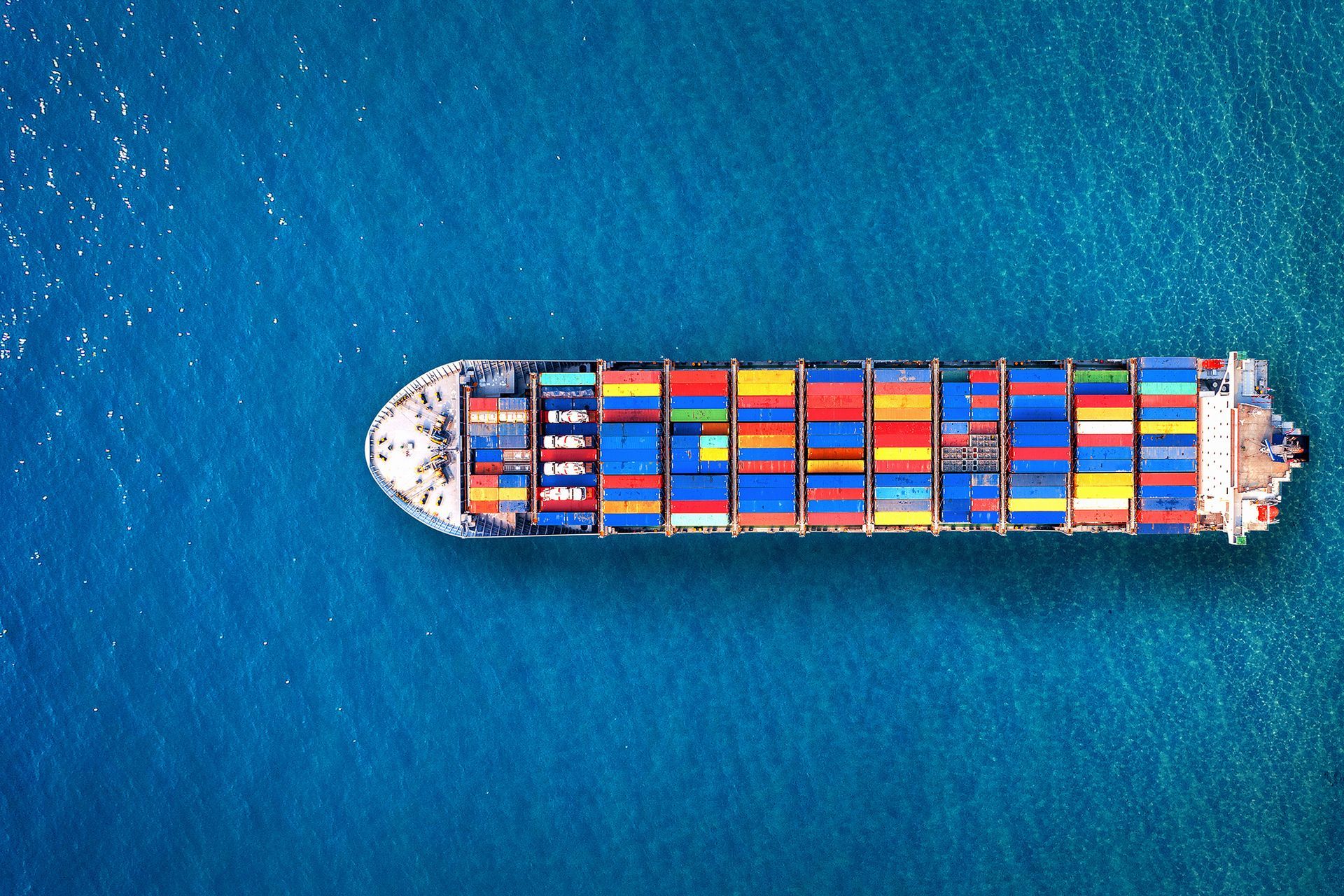 An aerial view of a large container ship in the ocean.