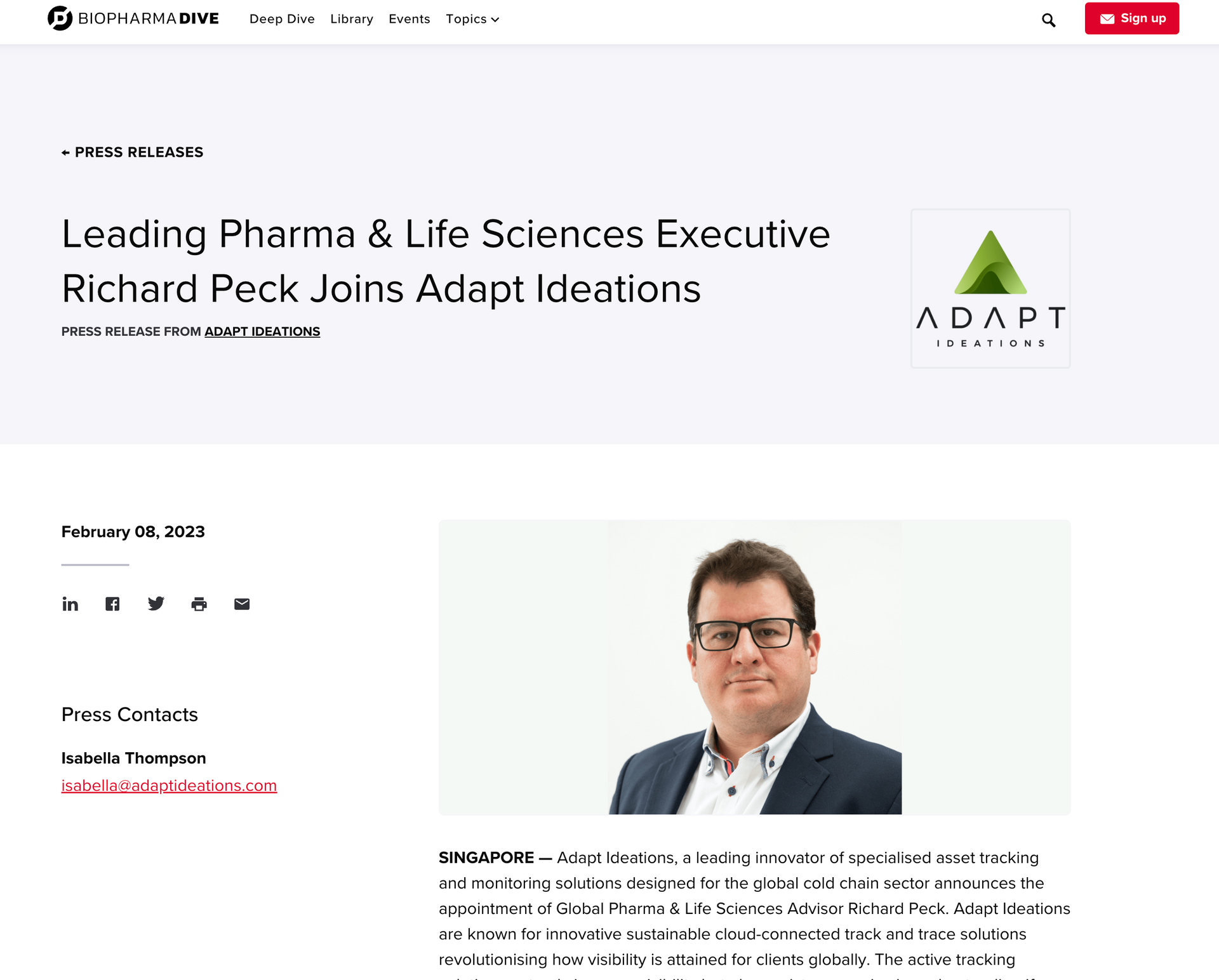 A man in a suit and glasses is on the homepage of a website.