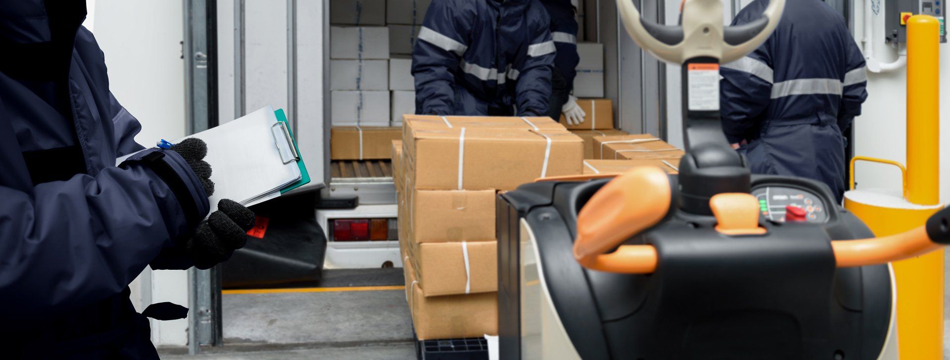 A group of men are loading boxes into a truck.