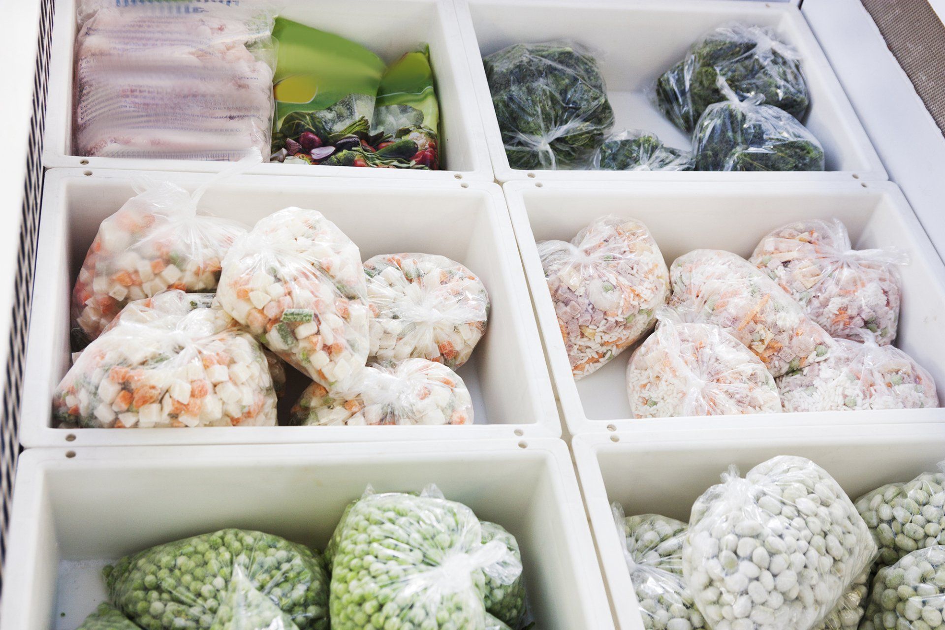 A refrigerator filled with a variety of frozen vegetables.