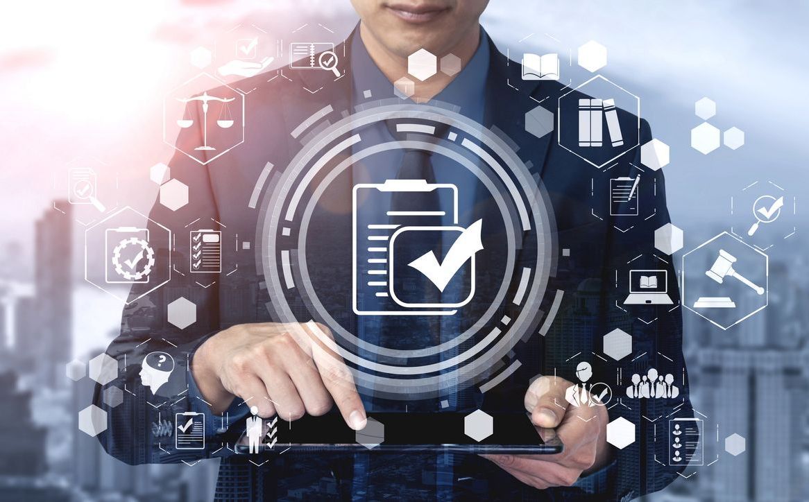 A man is holding a tablet with a check mark on it.
