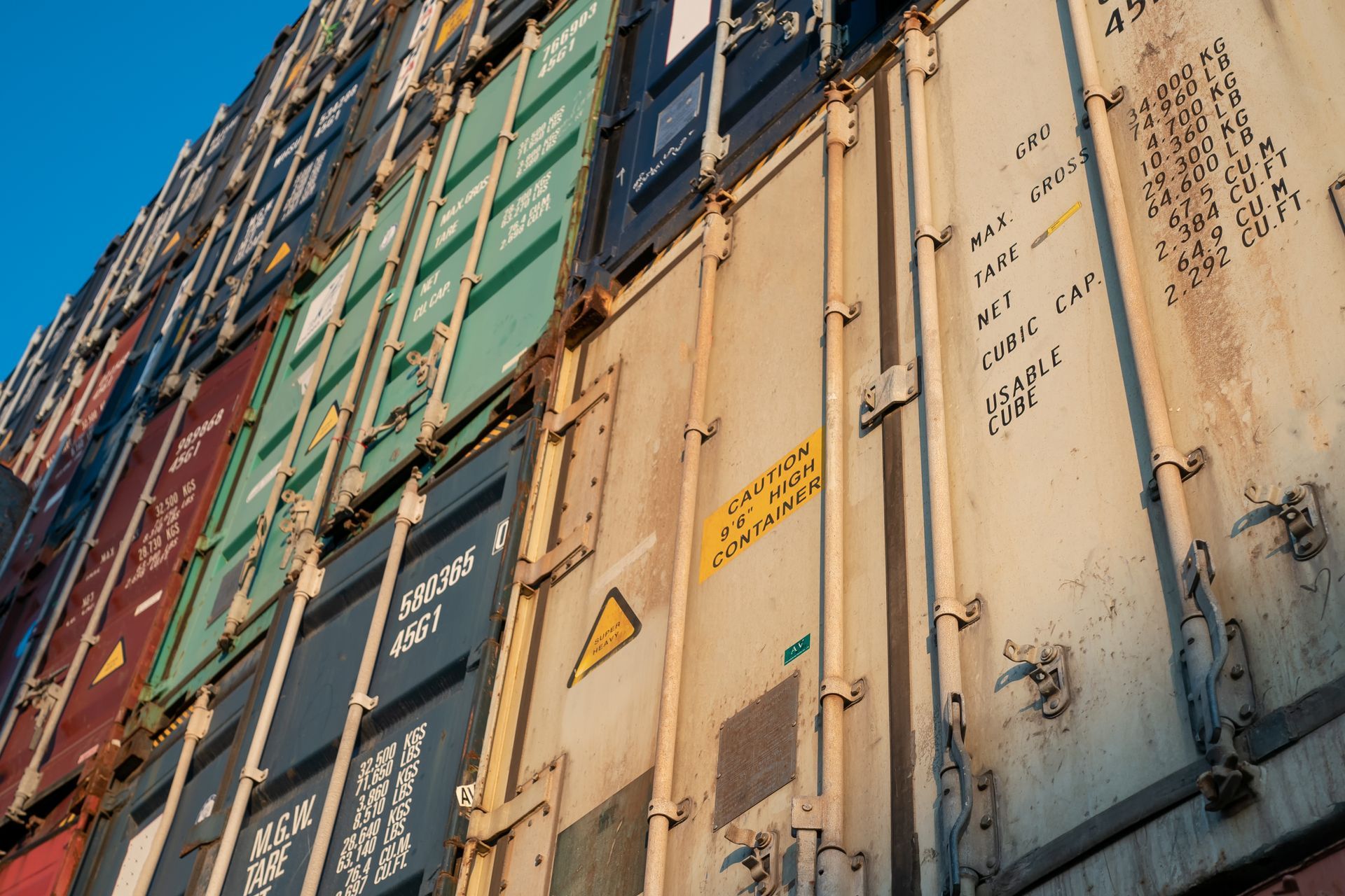 A row of shipping containers are stacked on top of each other.