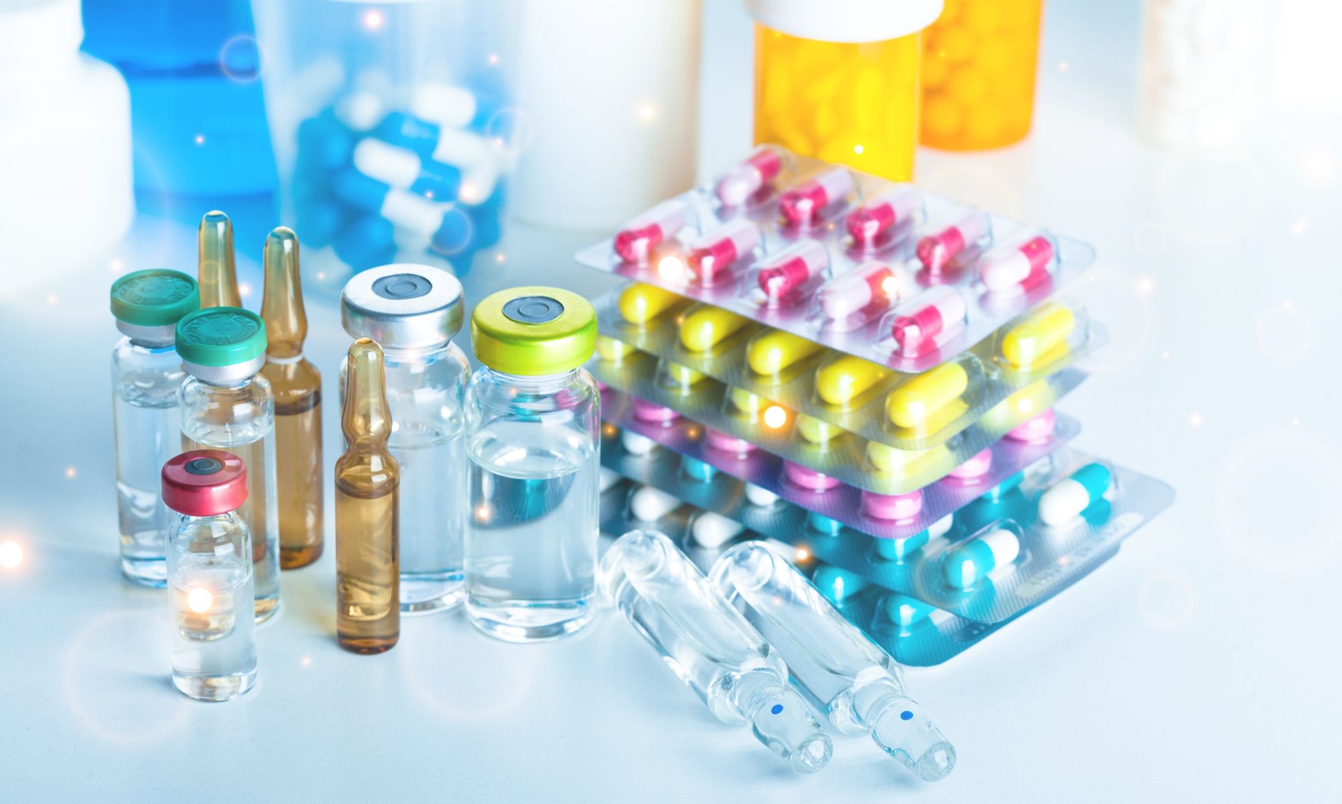 There are many different types of pills and bottles on the table.