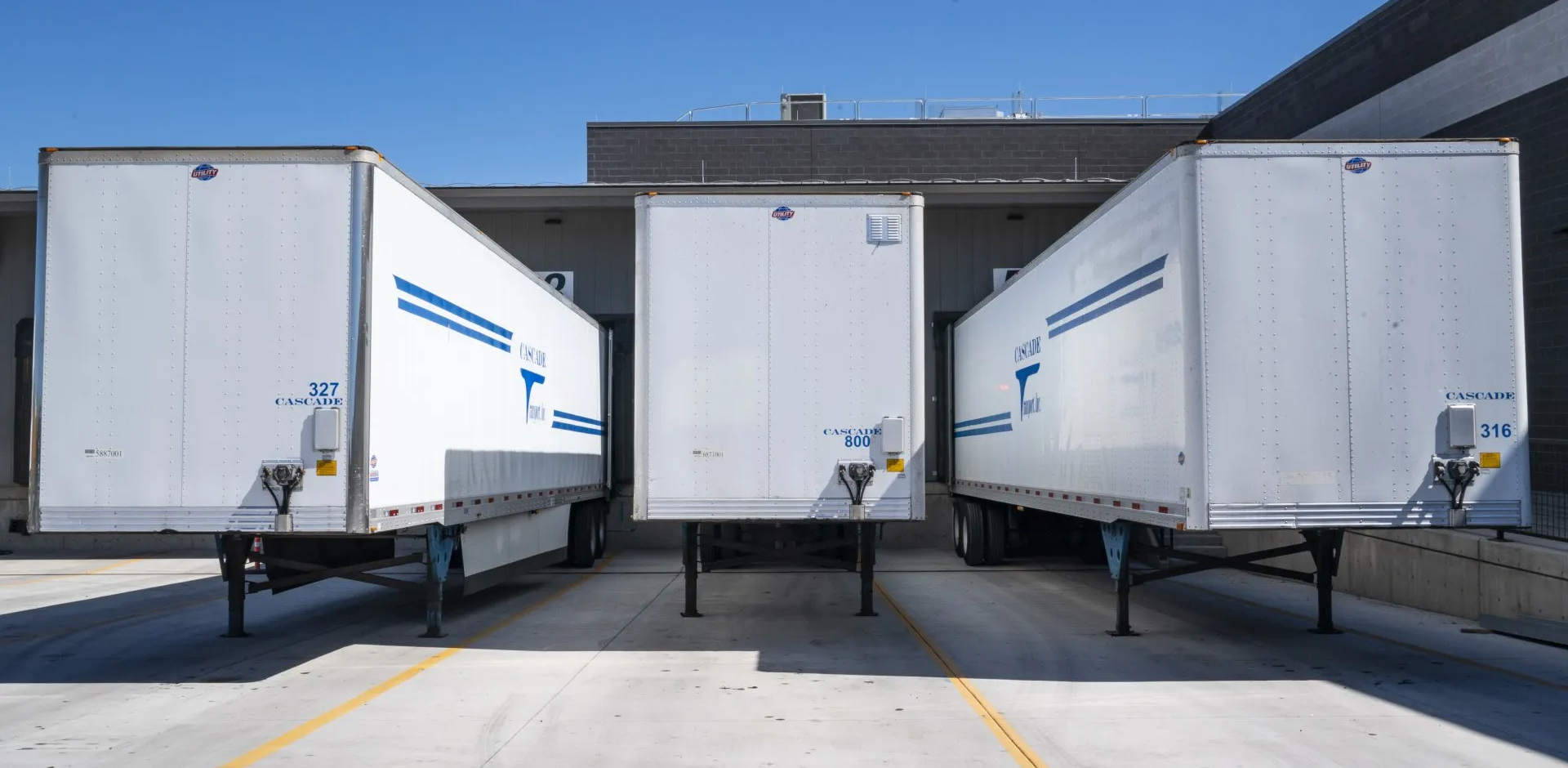 Importance of Effective Cold Chain Management A row of white trailers are parked in front of a building