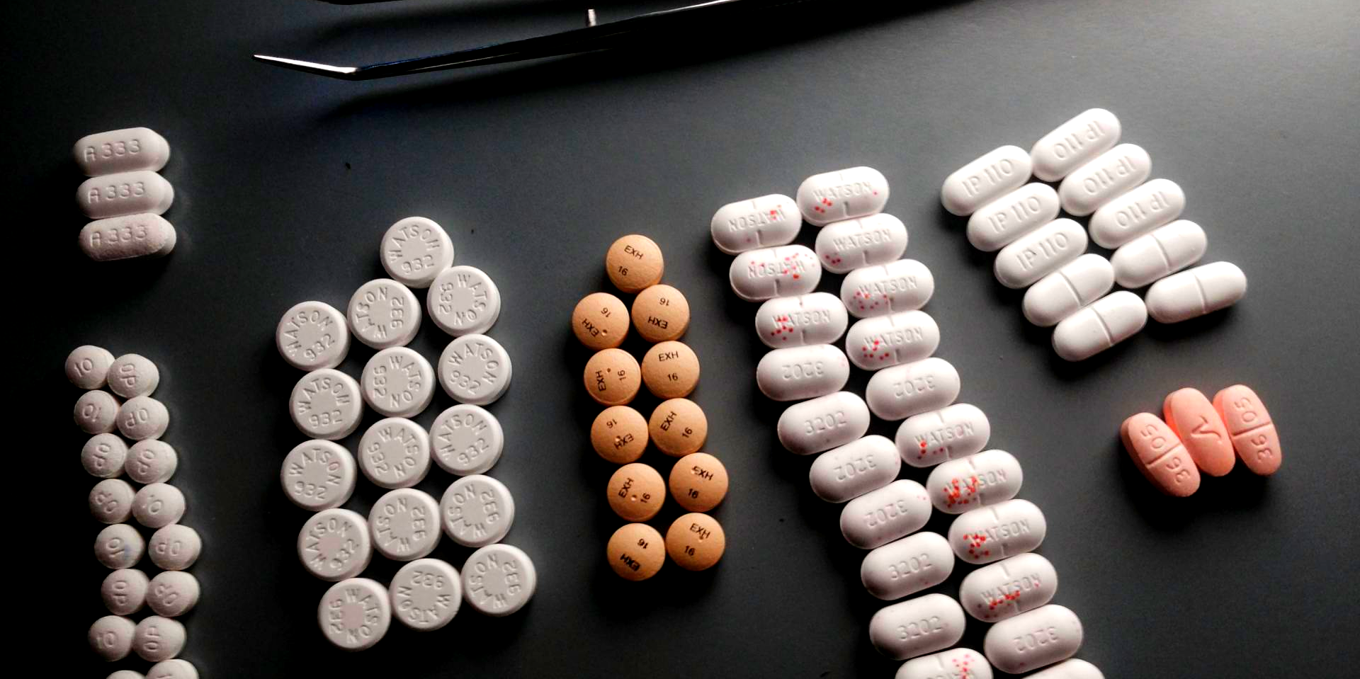 A bunch of different types of pills on a table