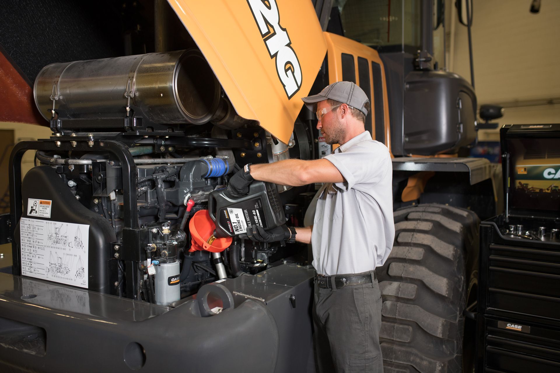 Service tech working on machine in garage
