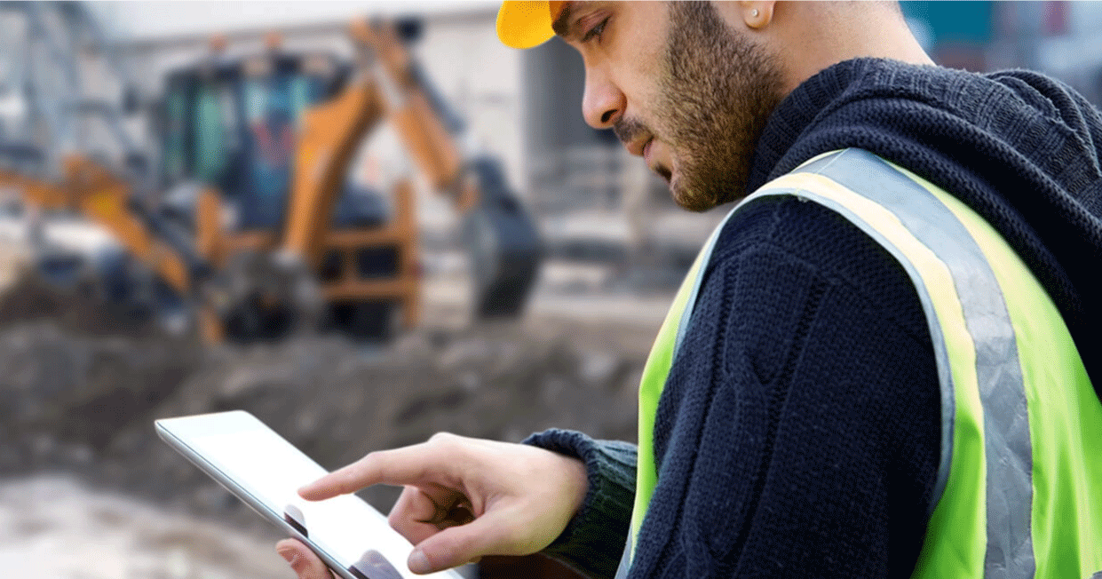 Construction worker looking at tablet