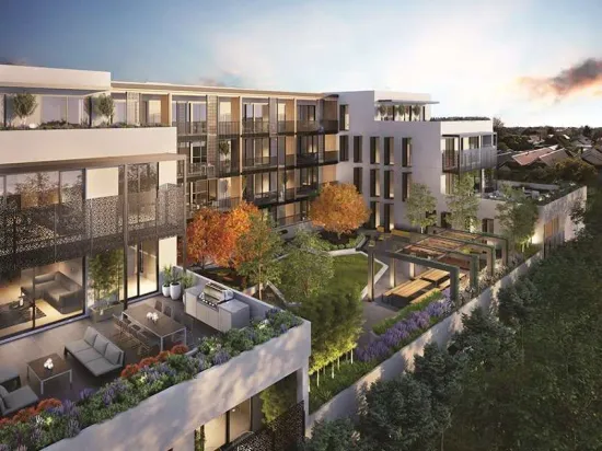 Modern multi-story apartment building with rooftop terraces and landscaping.