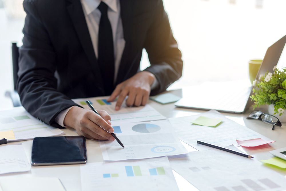 Person in A Suit Reviews Financial Documents — Freedom Wealth Solutions in Leongatha, VIC